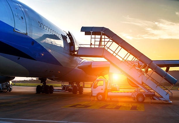 airplane near the terminal in an airport at the sunset